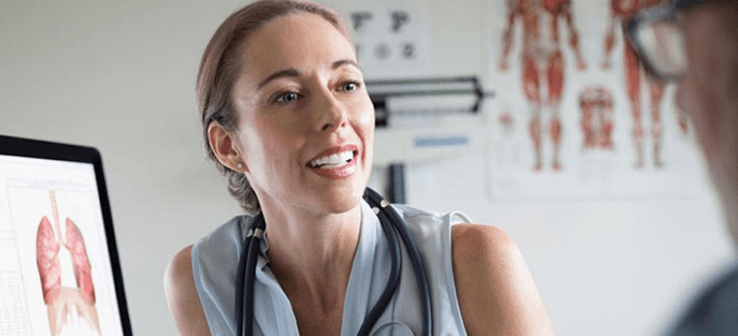 Doctor speaking with patient and smiling