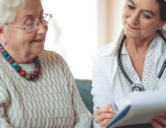 Doctor and elderly female patient reviewing results