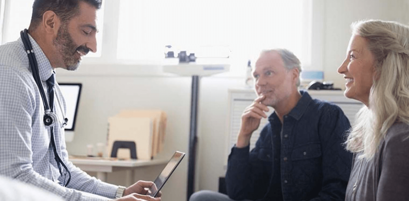 Doctor using iPad in front of patients