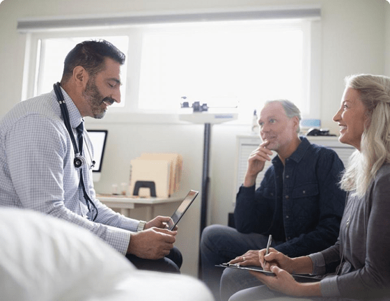 Doctor using iPad in front of patients