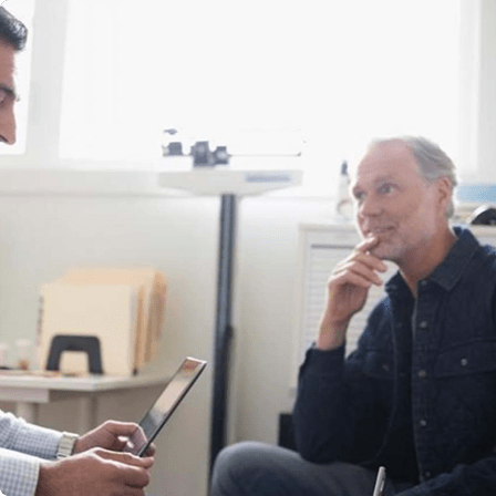 Doctor using iPad in front of patients