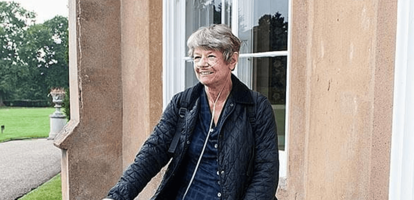 Elderly lady using oxygen tubes whilst walking around