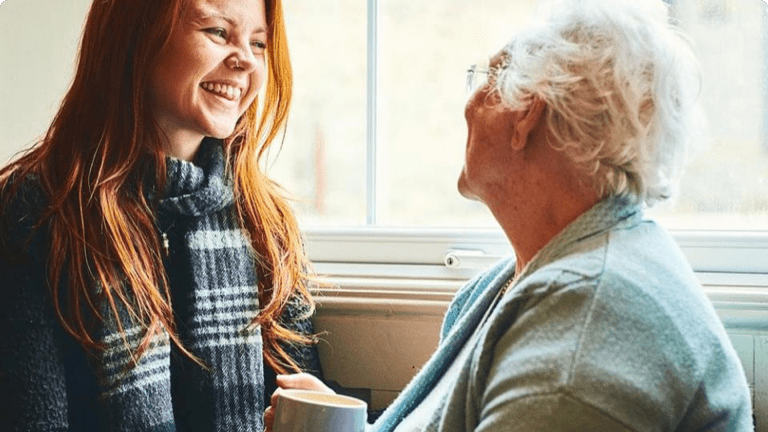  Grandmother_and_granddaughter_smiling_together_by_a_window-three-card