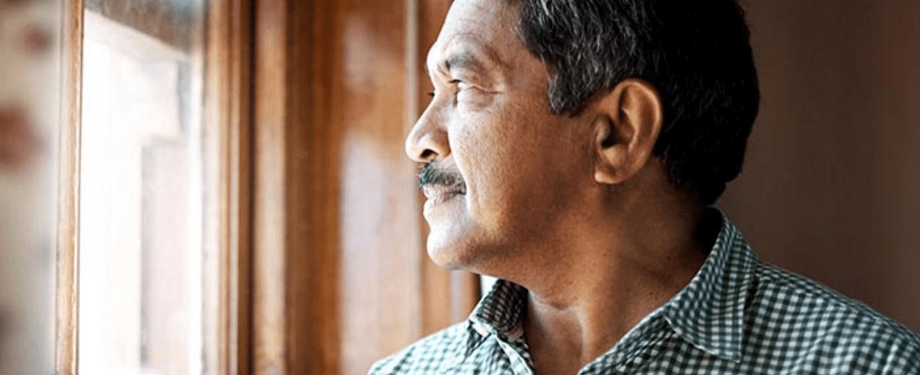 Man pensively looking out of the window