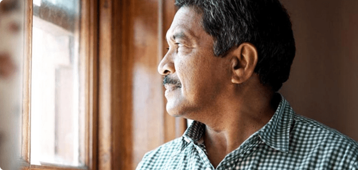 Man pensively looking out of the window