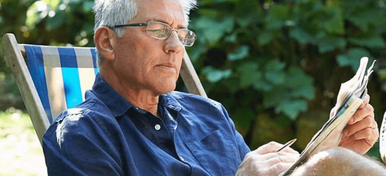 Middle aged man reading with glasses