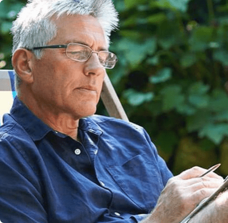 Middle aged man reading with glasses
