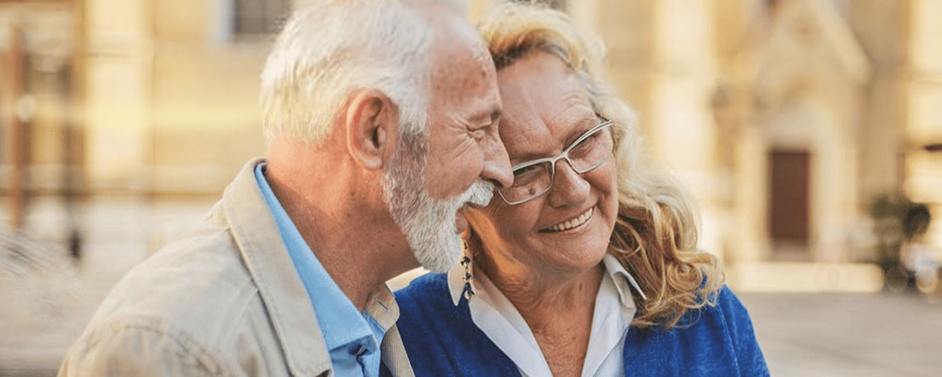 Older couple outside, smiling together