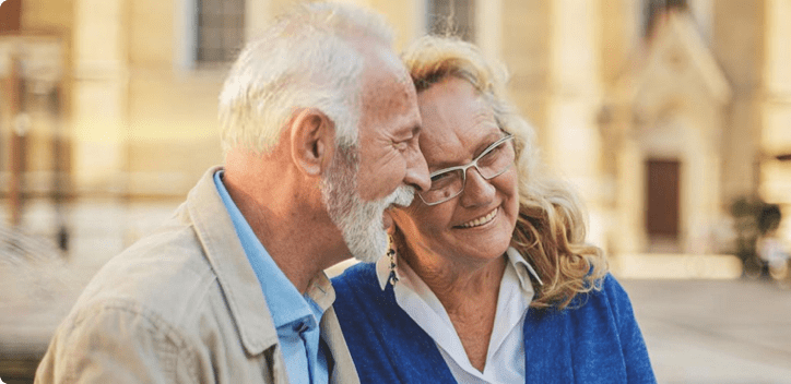 Older couple outside, smiling together