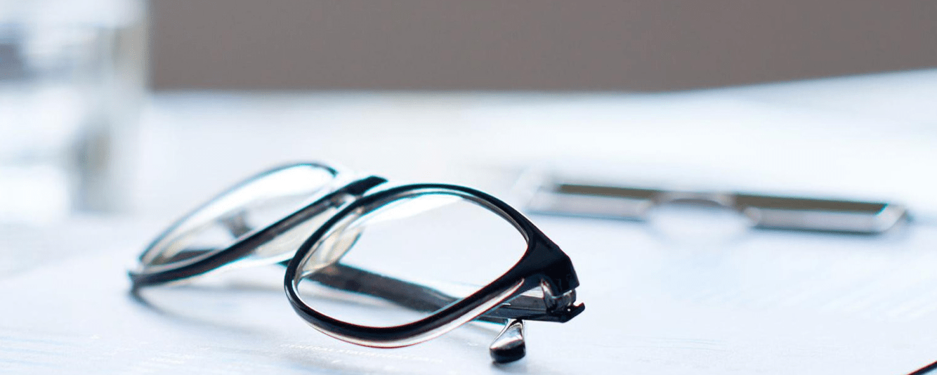 Pair of glasses sitting on a clipboard