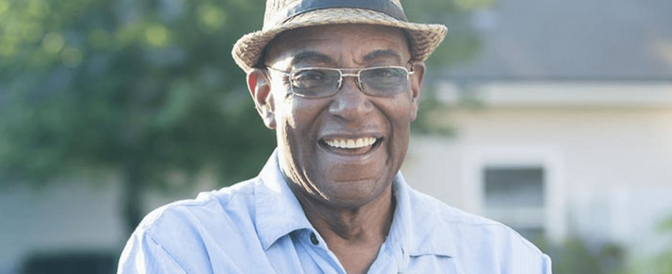Smiling man standing in a garden
