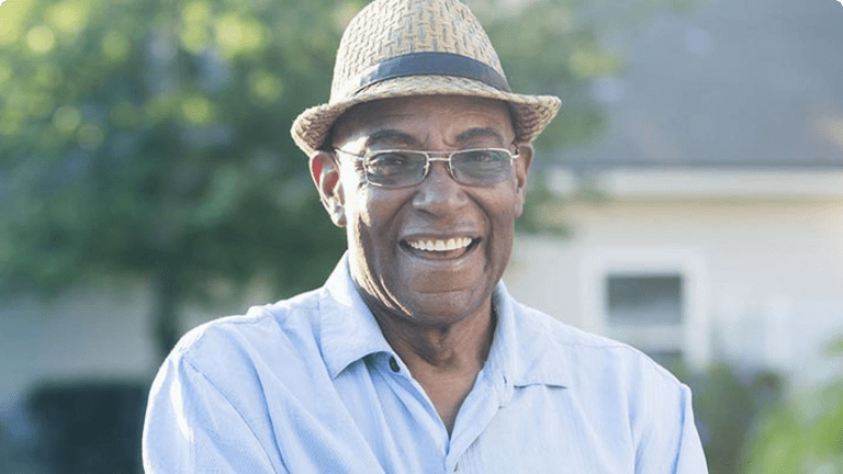 Smiling man standing in a garden
