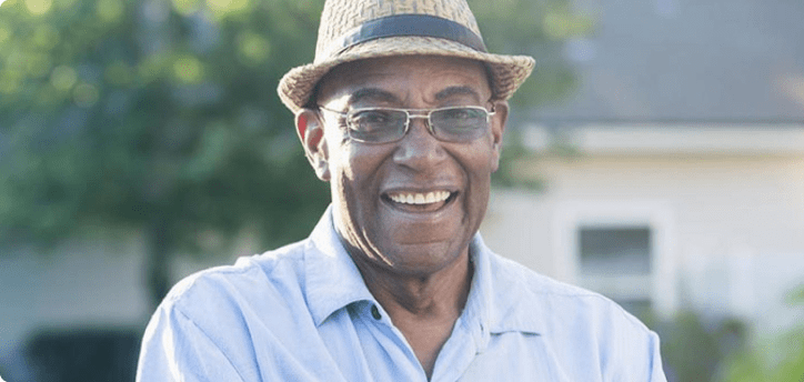 Smiling man standing in a garden