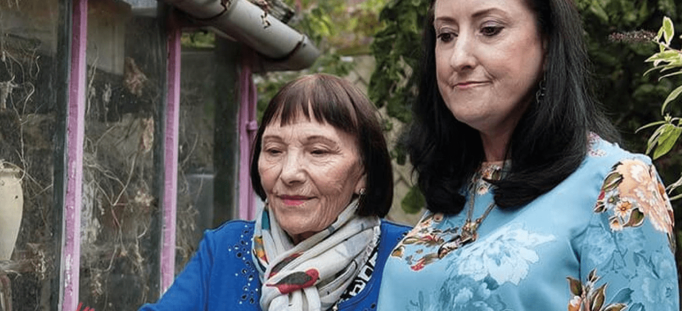 Two ladies walking in the garden