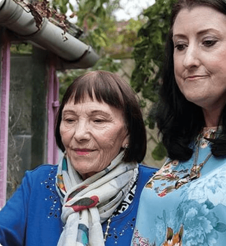 Two ladies walking in the garden