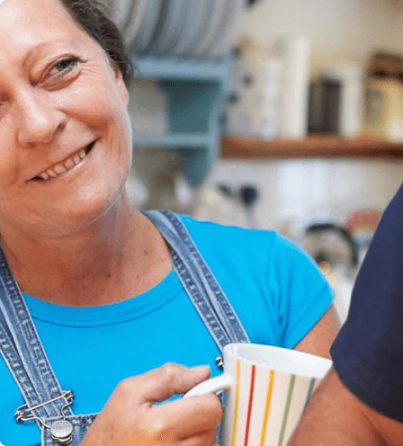 Woman smiling with cup in hand