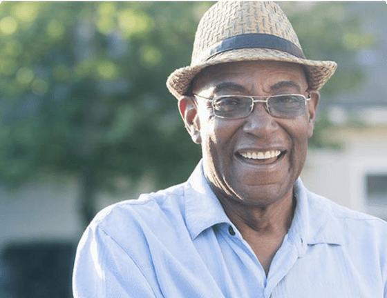 Smiling man standing in a garden